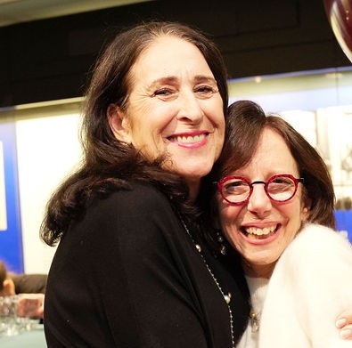 Jacquie Bayley-Sue Beller hugging-cropped to square A photo of Andrea and Moshe Silagi. Both are smiling at the camera.